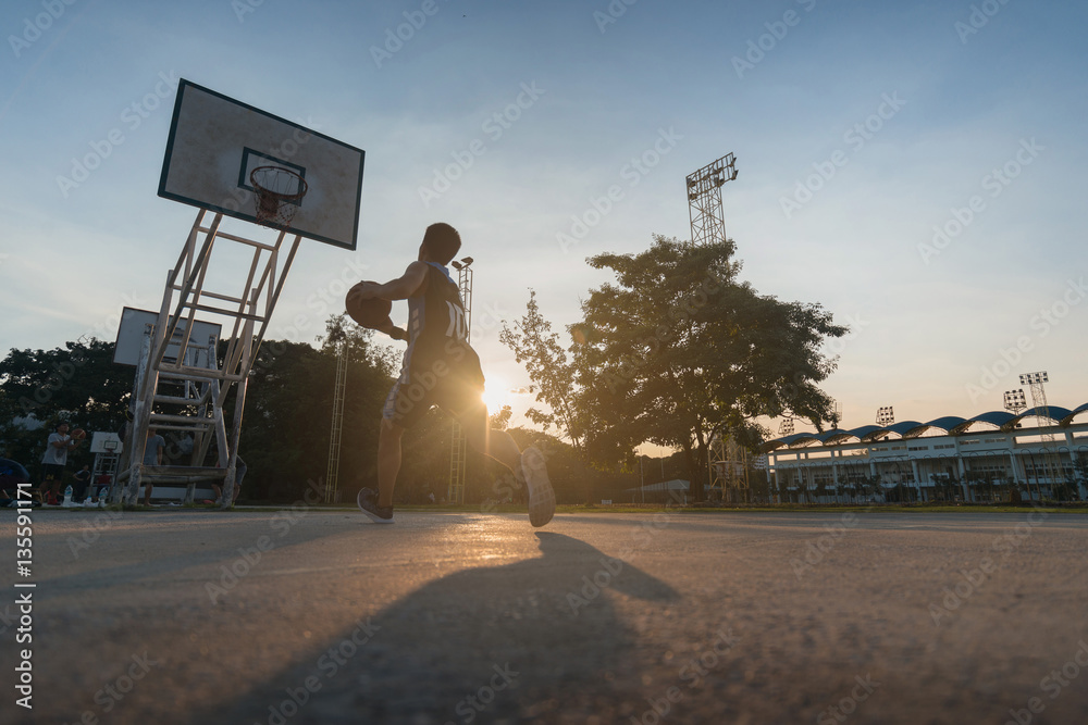 Obraz premium Basketball players playing basketball outdoor.
