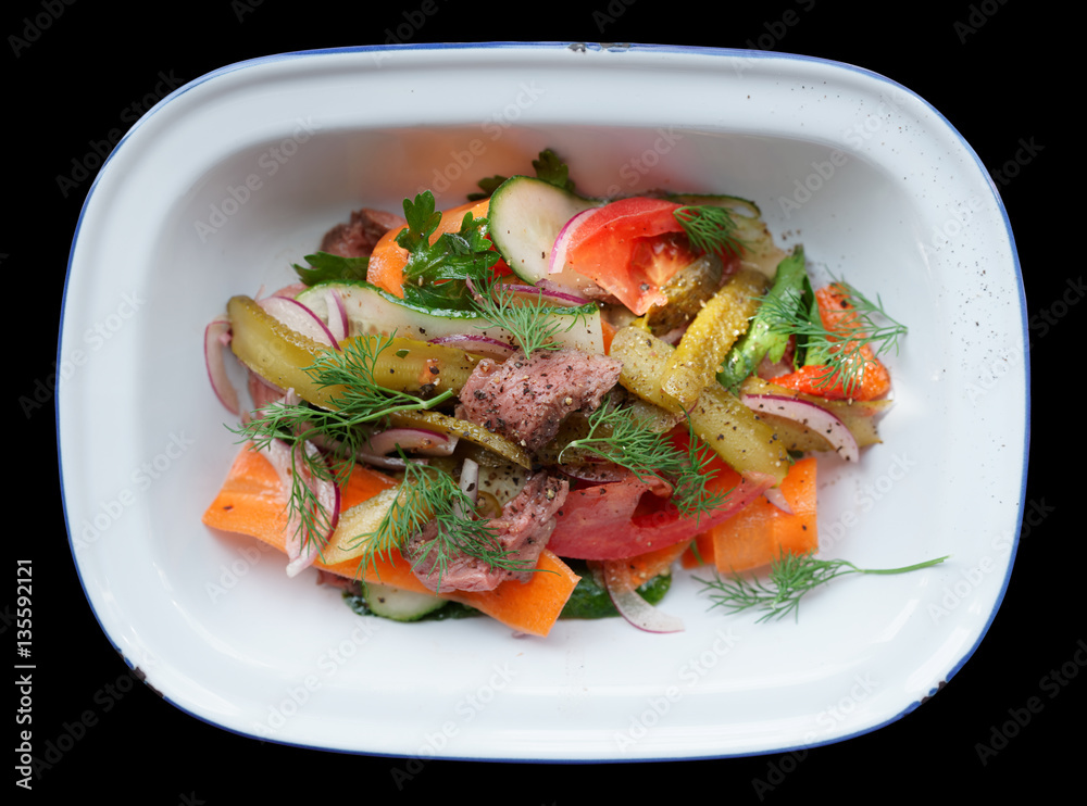 Roast beef and vegetables in enamel plate isolated on black Roast beef and vegetables in enamel plate isolated on black
