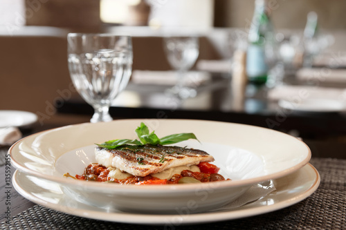 Sea bass fillet with tomato sauce and capers
