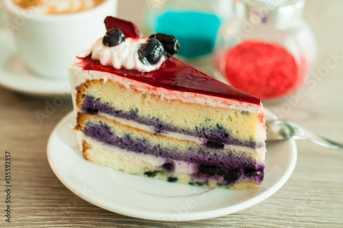 Cream cake with berries on the table layer. Wooden background, banner for confectionery