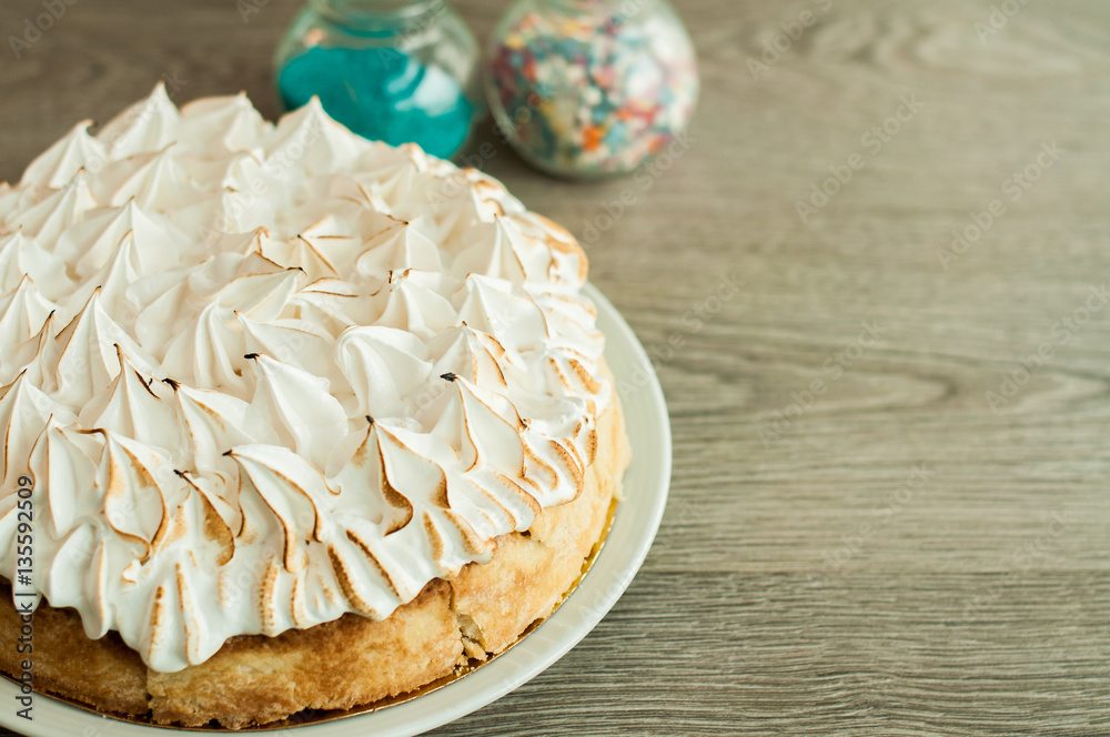 Sponge cake and cake on the table. Wooden background, banner for confectionery Sponge cake and cake on the table. Wooden background, banner for confectionery