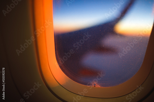 Clouds and sky as seen through window of an aircraft