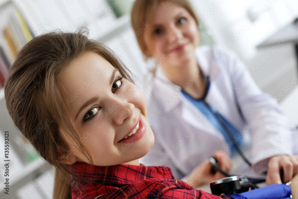 Smiling female patient sitting at medicine doctor office