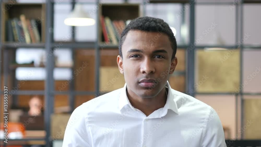 Black Man Pointing to Camera in Office Black Man Pointing to Camera in Office