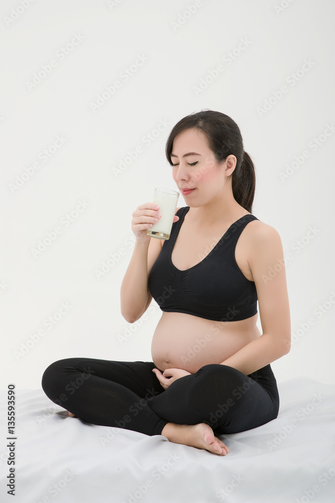 Pregnant Woman Smelling and Drinking Milk