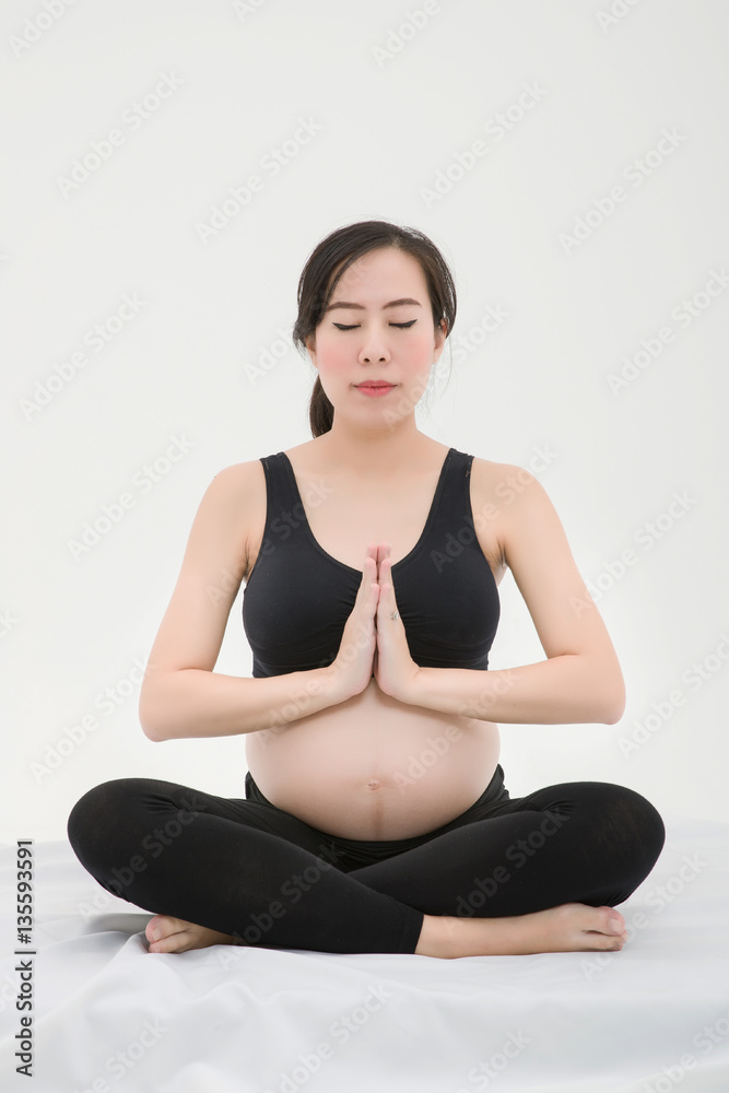 Pregnant Woman Sitting Cross-legged and Put her Palms together Pregnant Woman Sitting Cross-legged and Put her Palms together