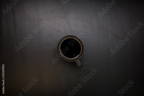 A cup of black coffee. View from above. The invigorating drink.