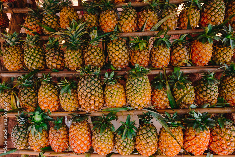 Rows of fresh pineapples for sale on a local market on side road in Thailand