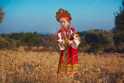 Small cute blonde girl in beautiful traditional Russian costume