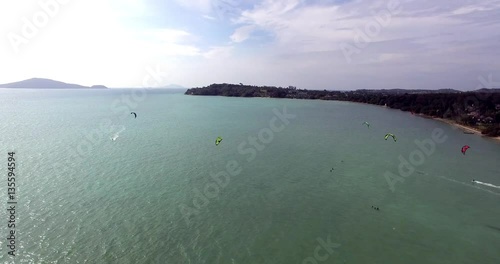 Kitesurfing on tropical island. Aerial view:kitesurfer sea rider rides at high speed. Travel concept. Thailand, Phuket. 4K video
