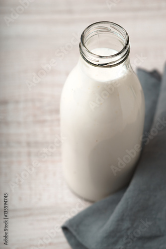 Kefir in a glass bottle on the wooden table