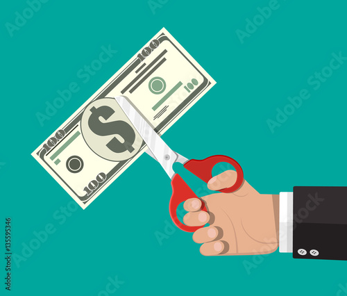 Businessman with scissors cutting dollar banknote