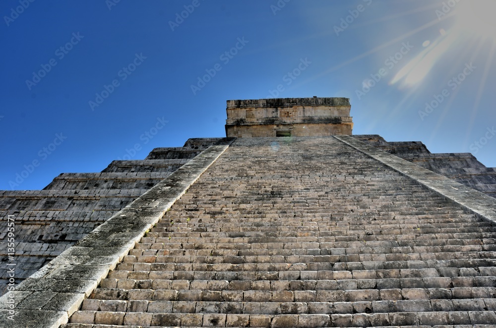 Steep steps leading up chichen itza temple in bright sun Steep steps leading up chichen itza temple in bright sun