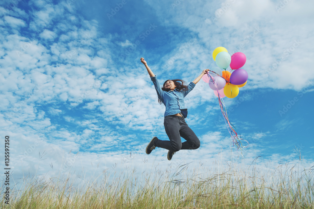 Beautiful woman at meadow with balloons in hand. Beautiful woman at meadow with balloons in hand.