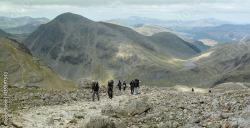 Hiking on Scafell Pike  looking back towards Great Gable, Sty Head Pass and Styhead Tarn in the Lake District, England, UK