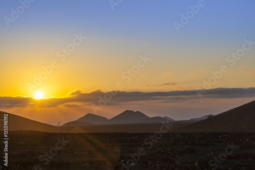 romantic sunrise on volcanic soil in La Geria