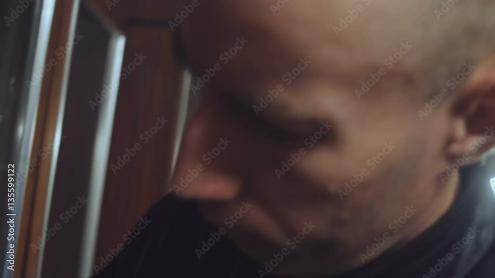 Bald man is looking for something in the cupboard close-up Bald man is looking for something in the cupboard close-up