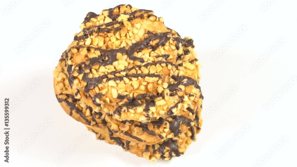 Cookies with nuts and chocolate rotates on a white table 4K Cookies with nuts and chocolate rotates on a white table 4K