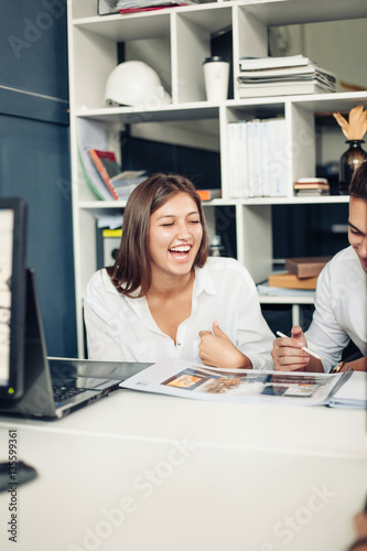 Couple of young designers working at modern office