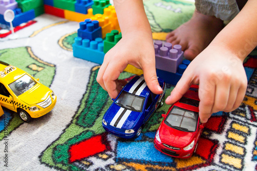 boy playing toy cars photo