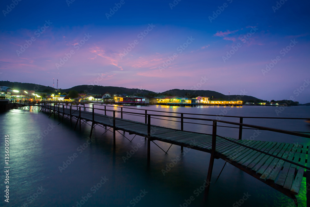 Walk way to pier at night time of colorful resort at pattaya thailand