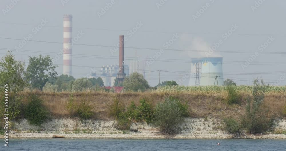 a Sandy Seabeach, With Two High Brick Towers, White Cylingrical Reservoir, Green Trees and Bushes, and Slowly Moving Waves a Sandy Seabeach, With Two High Brick Towers, White Cylingrical Reservoir, Green Trees and Bushes, and Slowly Moving Waves