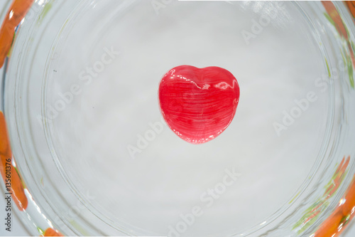 red heart candy on the glass