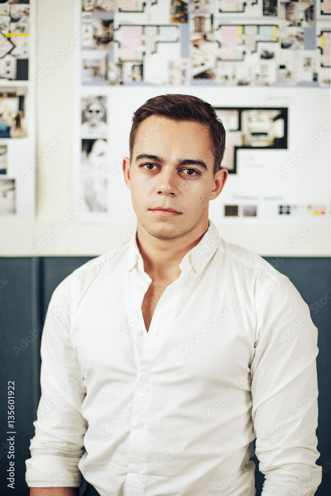 Portrait of a smart young man standing with arms crossed Portrait of a smart young man standing with arms crossed