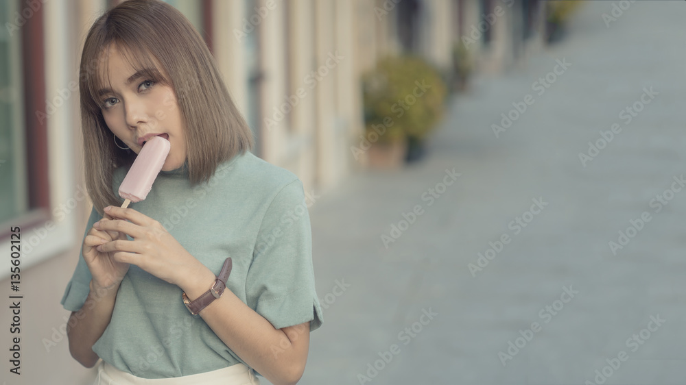 Happy woman eating ice cream with copyspace