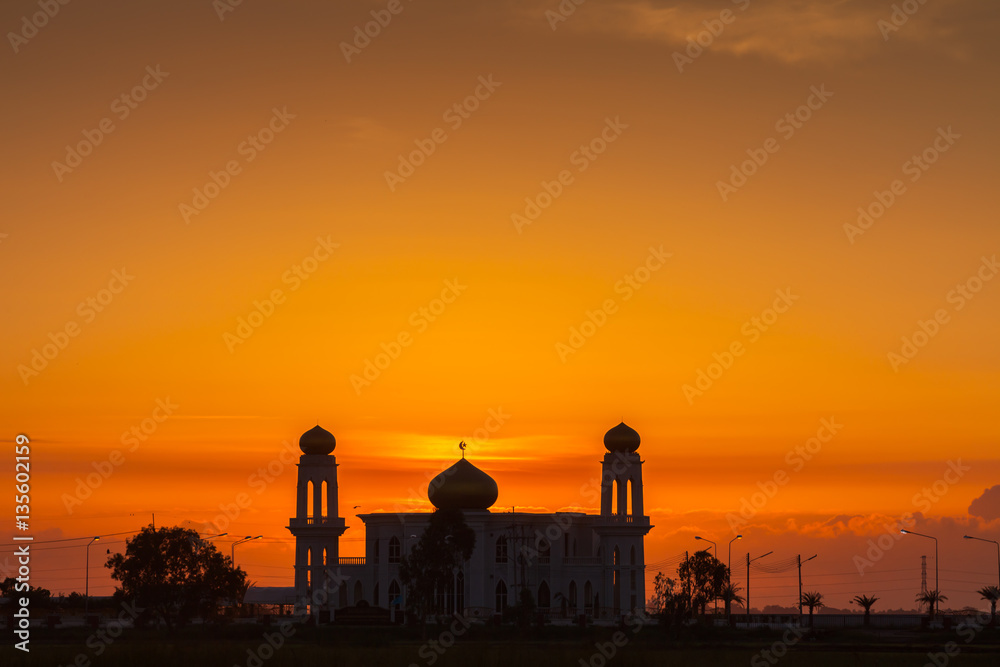 A silhouette of a mosque at sunrise vivid color , Thailand
