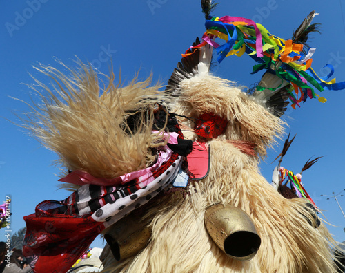 Pernik, Bulgaria - January 28, 2017: Masquerade festival Surva in Pernik, Bulgaria. People with mask called Kukeri dance and perform to scare the evil spirits. photo