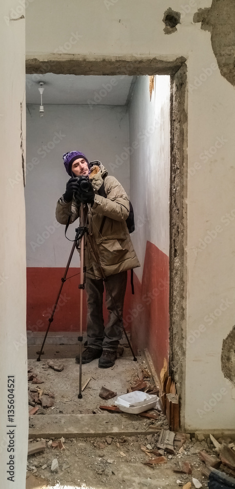 Photographer shooting in a ruined abandoned apartment Photographer shooting in a ruined abandoned apartment