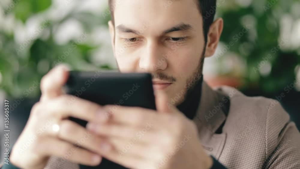 Closeup portrait of successful businessman using digital tablet in a cafe Closeup portrait of successful businessman using digital tablet in a cafe