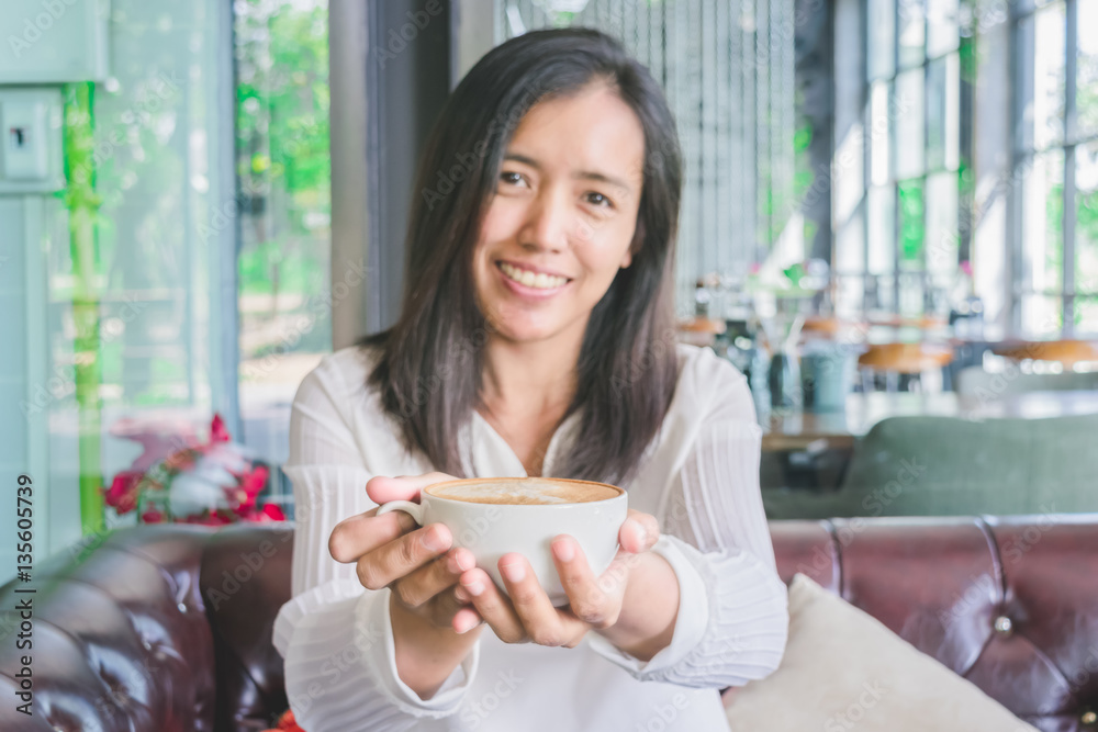 Portrait of happy asian woman with coffee mug in her hands. Loving coffee concept. Portrait of happy asian woman with coffee mug in her hands. Loving coffee concept.