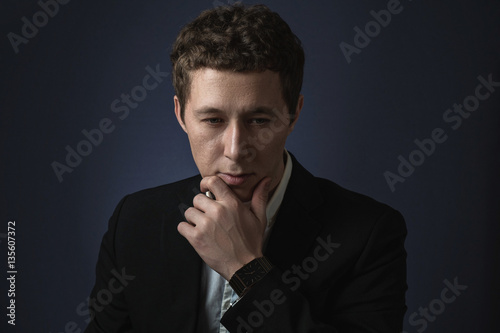business man in suit standing brooding