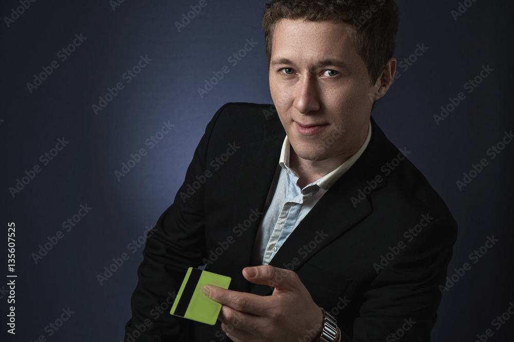 business man in suit stretches credit card