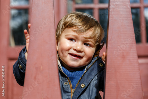 A happy child looks and smiles photo