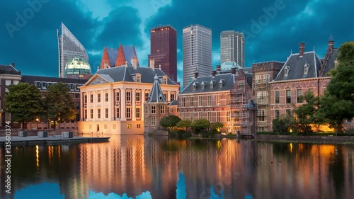 Evening view on Binnenhof Palace and high modern buildings in Hague (static image with animated sky and water)
