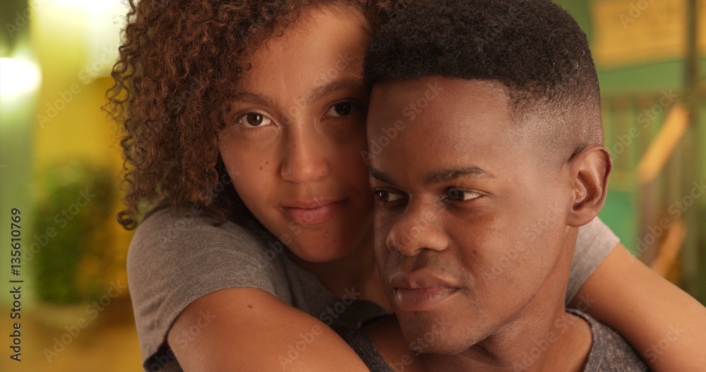 Close-up portrait of African American man and woman embracing each other on a night on the town Close-up portrait of African American man and woman embracing each other on a night on the town