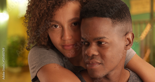 Close-up portrait of African American man and woman embracing each other on a night on the town