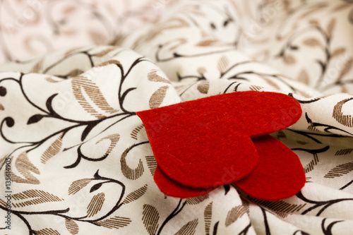 Small red heart from felt on linen