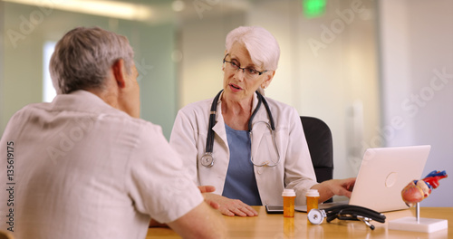 Senior doctor talking with elderly man in the office