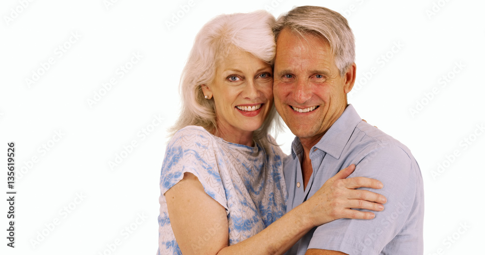 Smiling senior couple looking at camera on white background Smiling senior couple looking at camera on white background