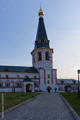 The road to the temple - Belfry of Monastery at twilight. Belfry with tent completion is a common element of the Russian church architecture of the XVII century. photo