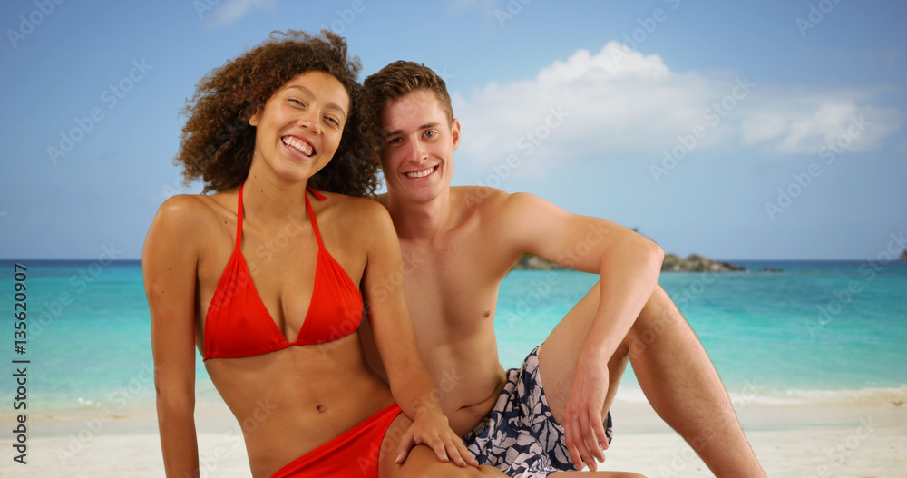 Attractive interracial friends posing on Caribbean beach.