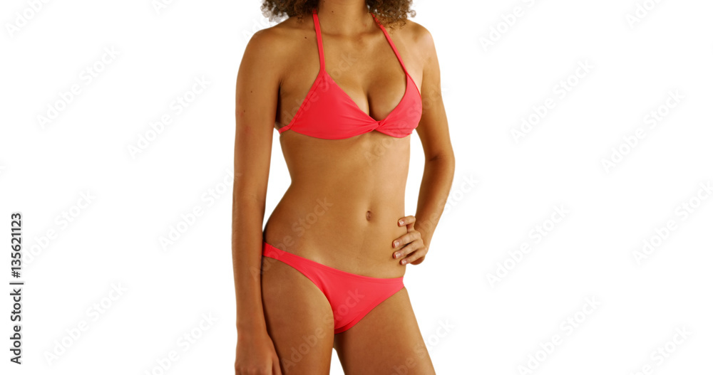 Fototapeta premium African woman in swimwear standing on copyspace.