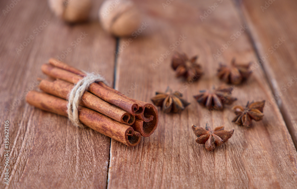 Cinnamon sticks and anise on a wooden background Cinnamon sticks and anise on a wooden background