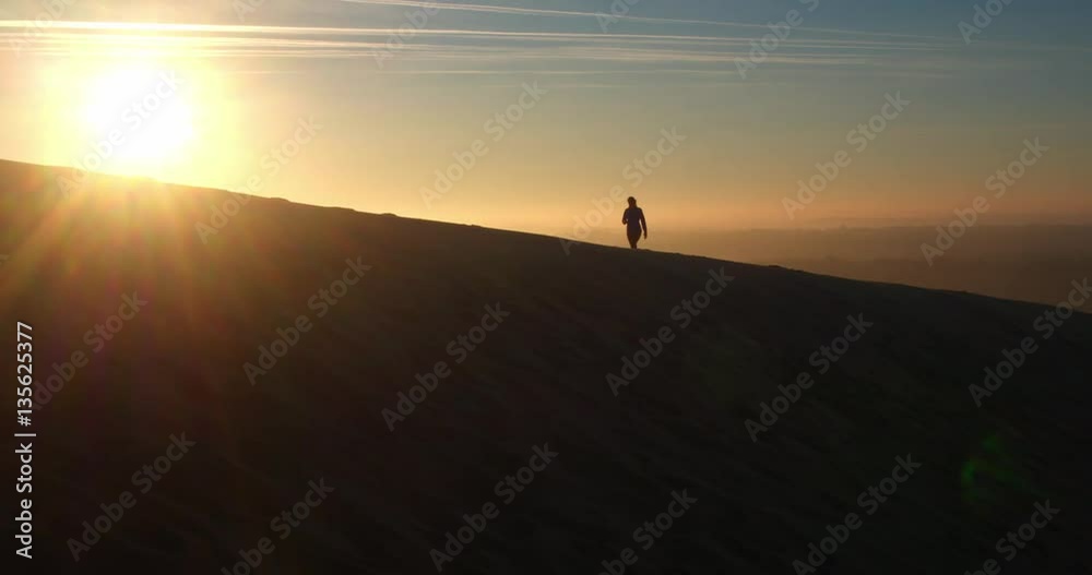 4k cinematic aerial drone shot, woman walking at beautiful sunrise, Dune du Pilat, Arcachon, France 4k cinematic aerial drone shot, woman walking at beautiful sunrise, Dune du Pilat, Arcachon, France