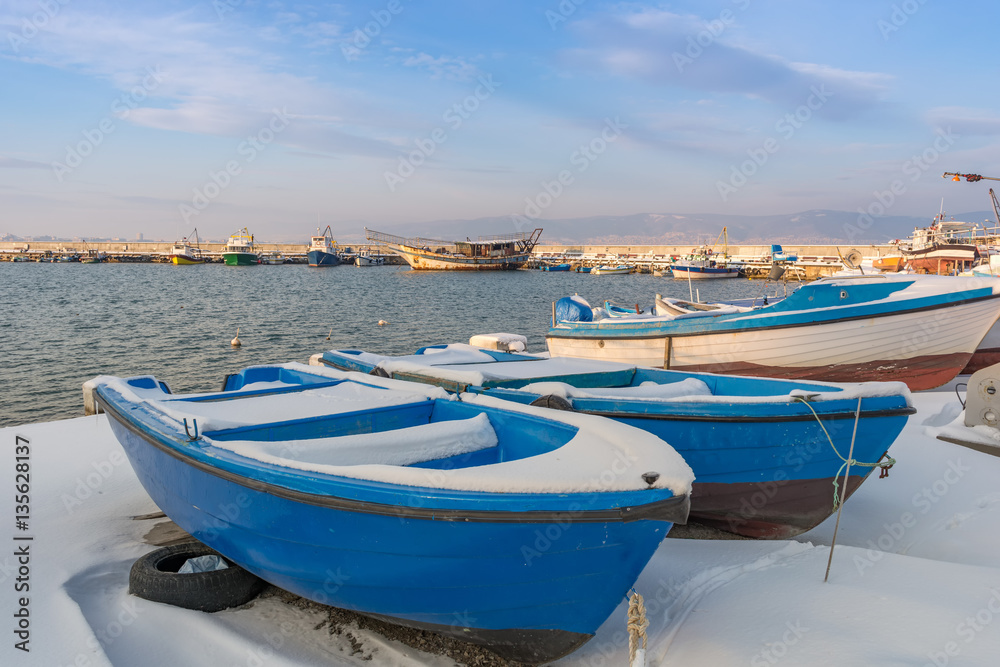 Nesebar, Bulgaria,Ships and boats covered in snow in the port of the old town Nessebar on the bulgarian Black Sea coast. UNESCO world heritage site