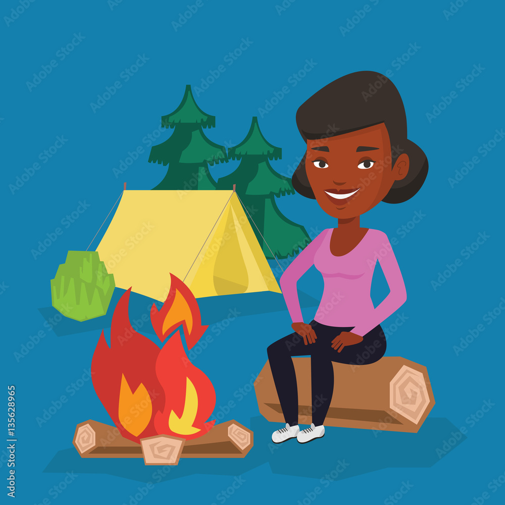 Woman sitting on log near campfire in the camping. Woman sitting on log near campfire in the camping.